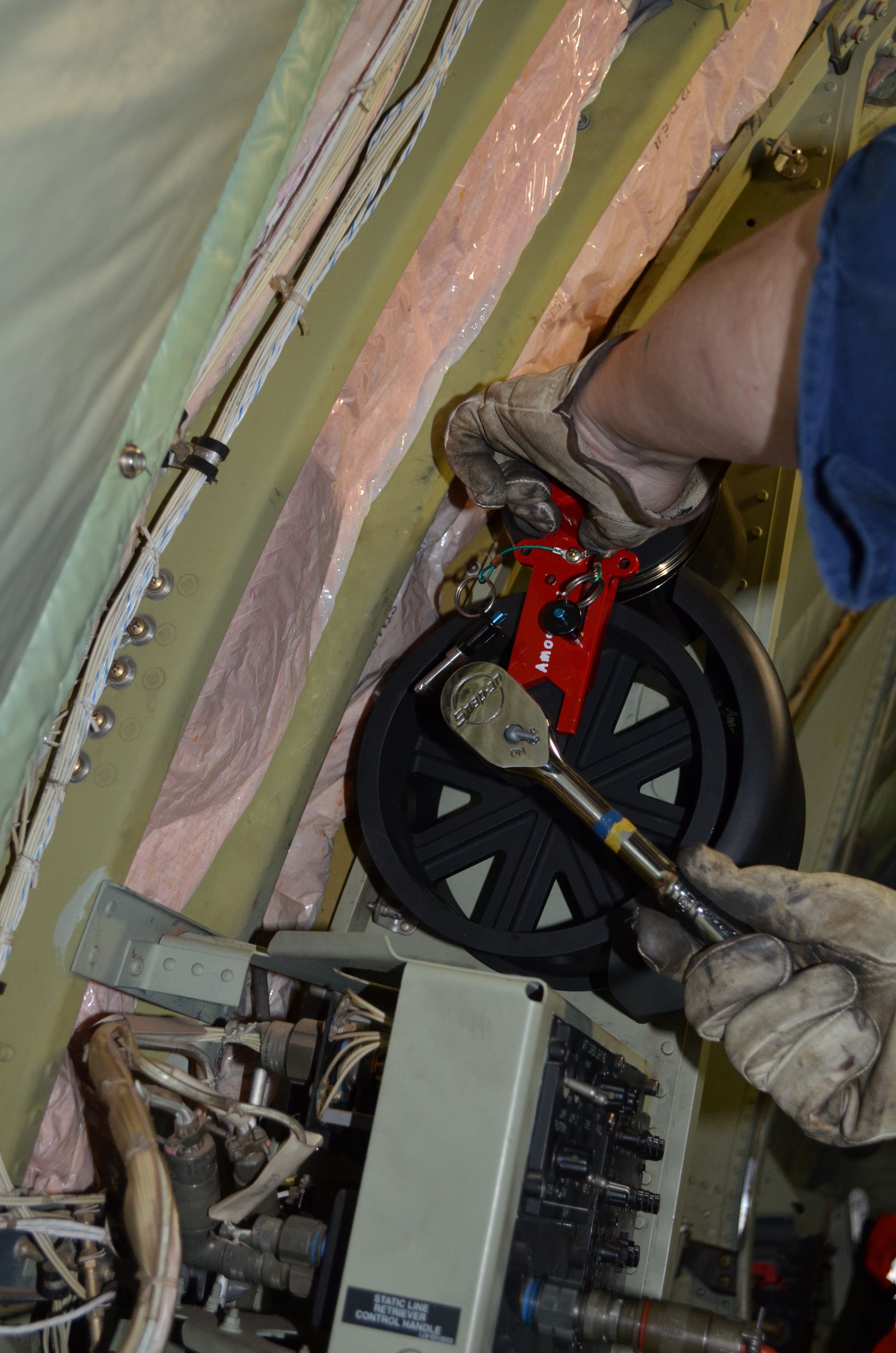 Technician utilizing Slide Spanner to service C-130 negator spring