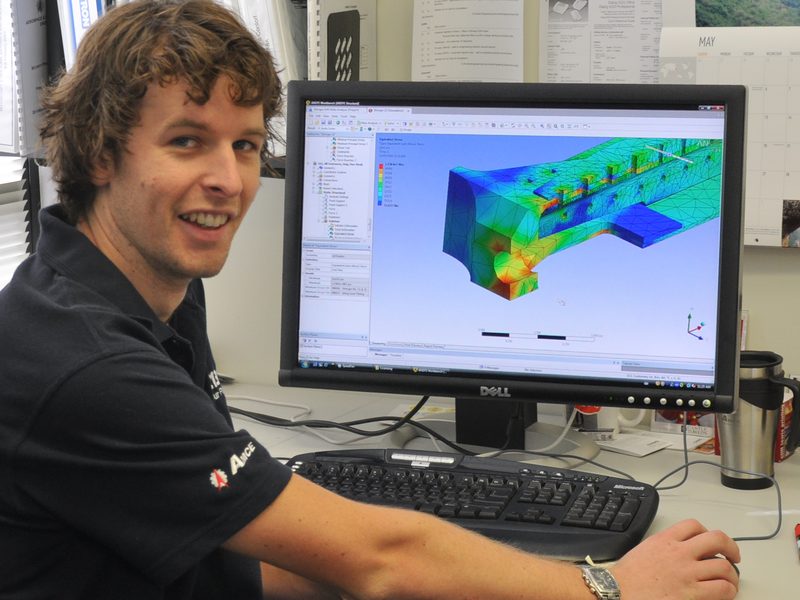 AMCE engineer reviewing a finite element analysis model at a workstation